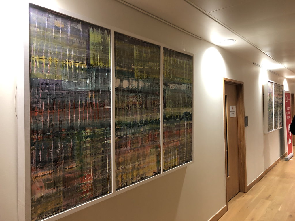 A corridor hung with a commissioned series of long panels