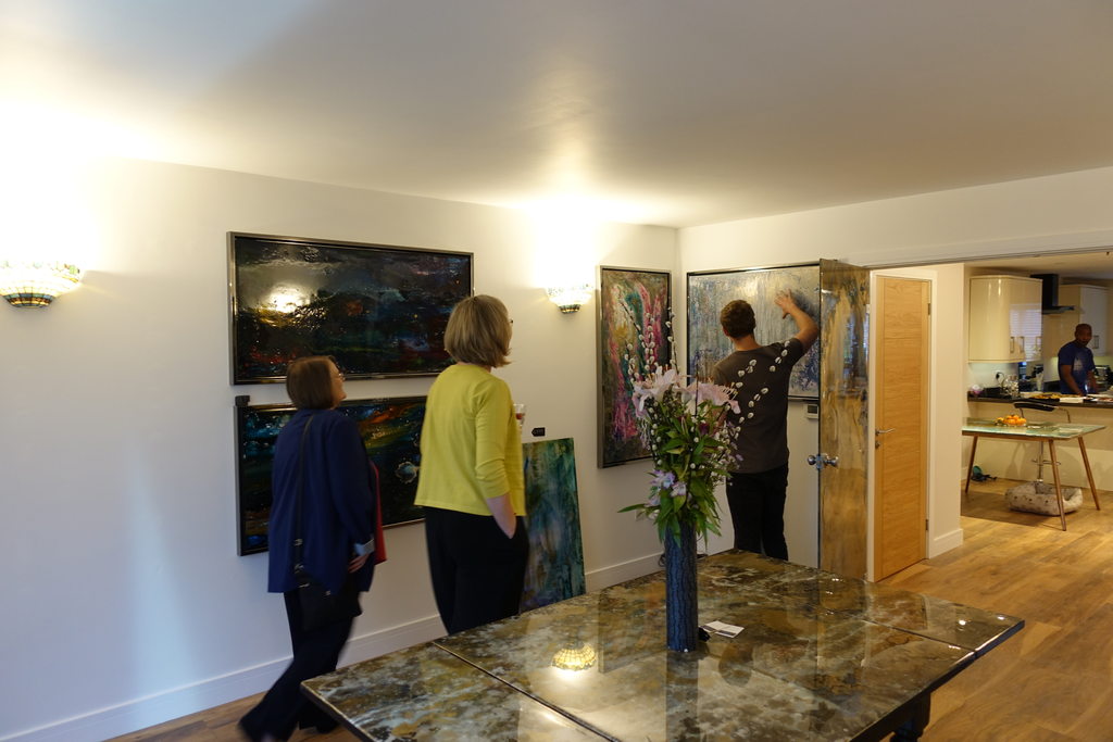 Visitors viewing paintings at an open-studio evening