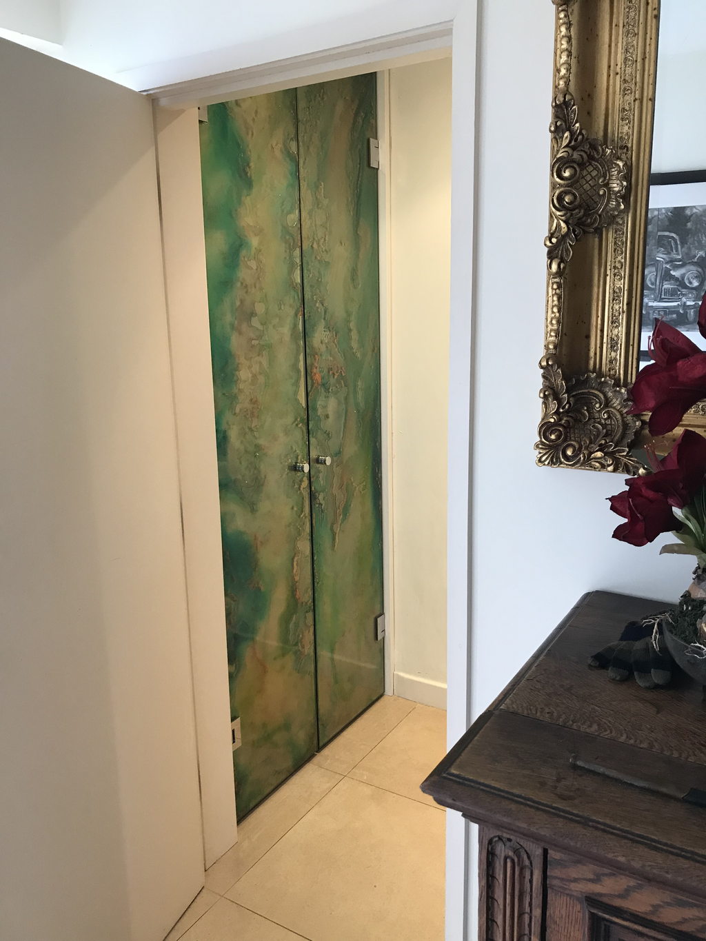 Verdant double doors: painted glass in greens and golds, installed in a private hallway